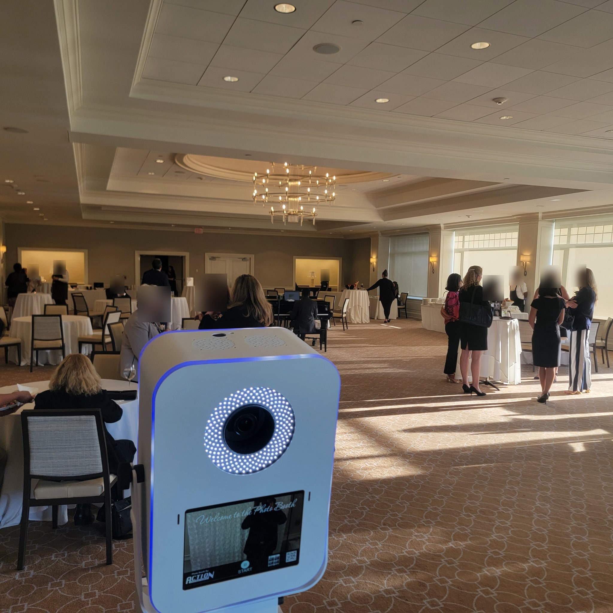 Photo booth kiosk with ring light ready in a decorated ballroom