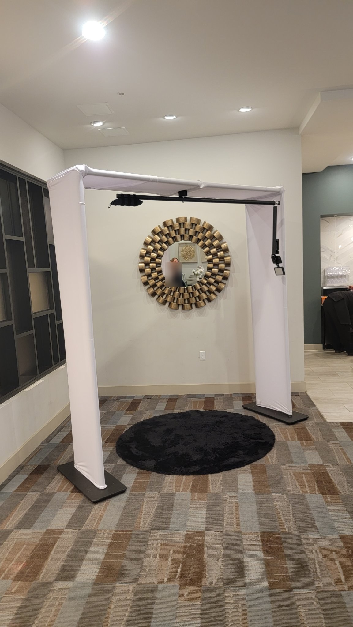 Overhead 360 photo booth rig with white draped columns ready for guests